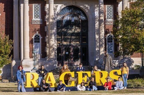 students surrounding RACERS sign